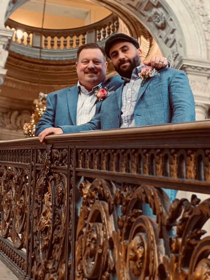 Sean and Cuneyt newlyweds, stairs of San Francisco's city hall